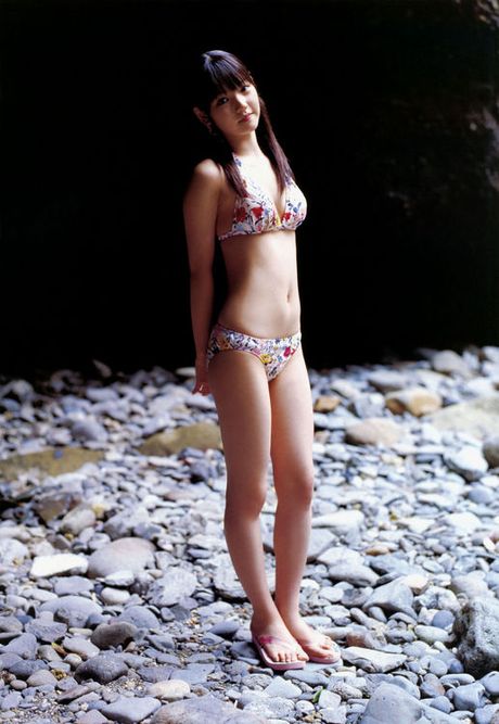 Two beautiful asian babes showing off their bodies in bikinis