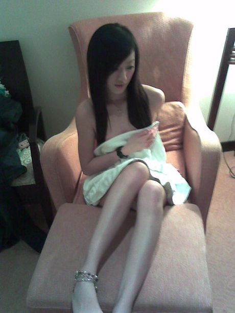 a sweet girl is photographed by her female friend posing nude