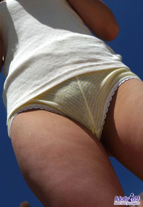 Perfect Japanese babe Asuka strips and highlights her hot ass on the beach