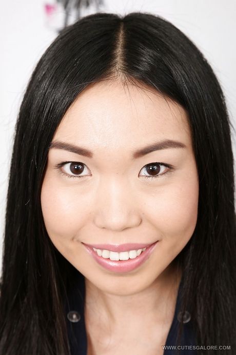 Shapely asian young Yiki in sexy skirt revealing tiny tits and pussy